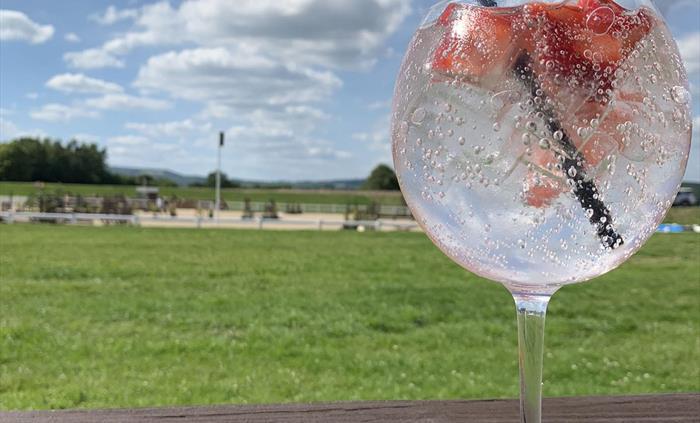 Enjoying all the Equestrian Action with a drink